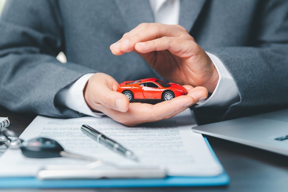 Man protecting his car - car insurance - quotes