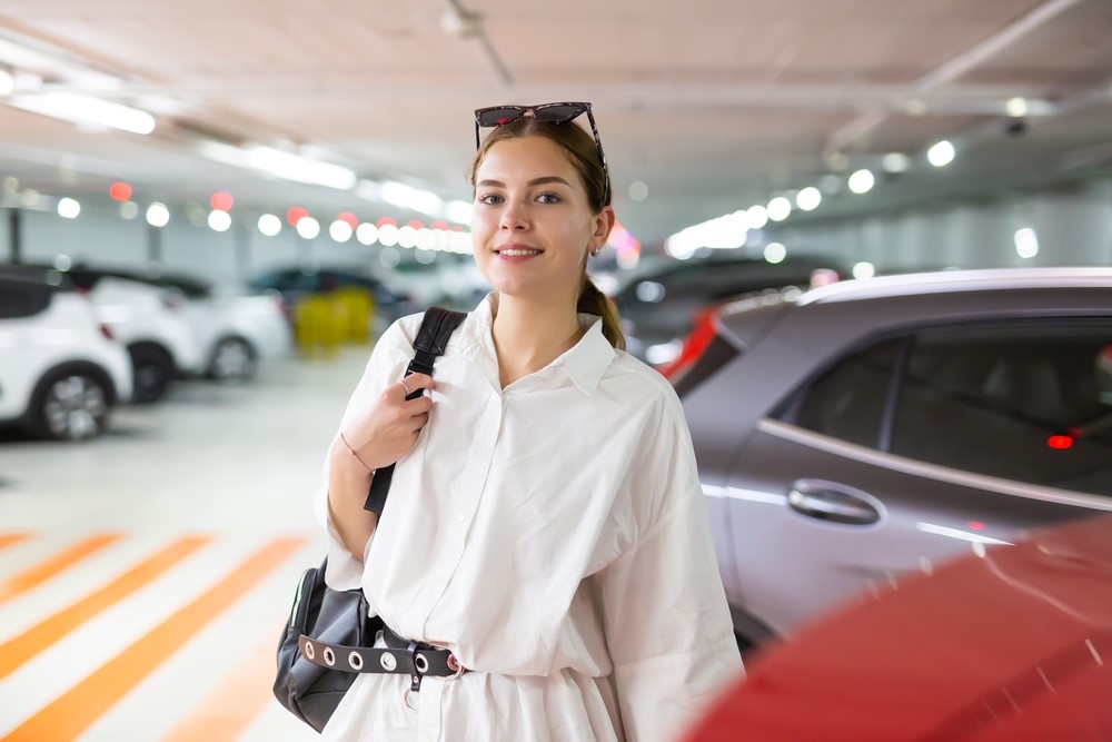 short term parking vs long term parking - women locking her car image